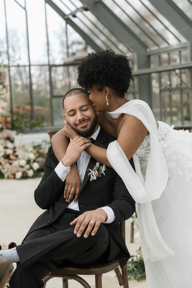 Bride, kissing the groom on the forehead