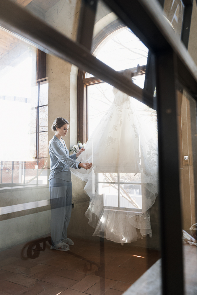 cute picture of the bride next to her wedding dress
