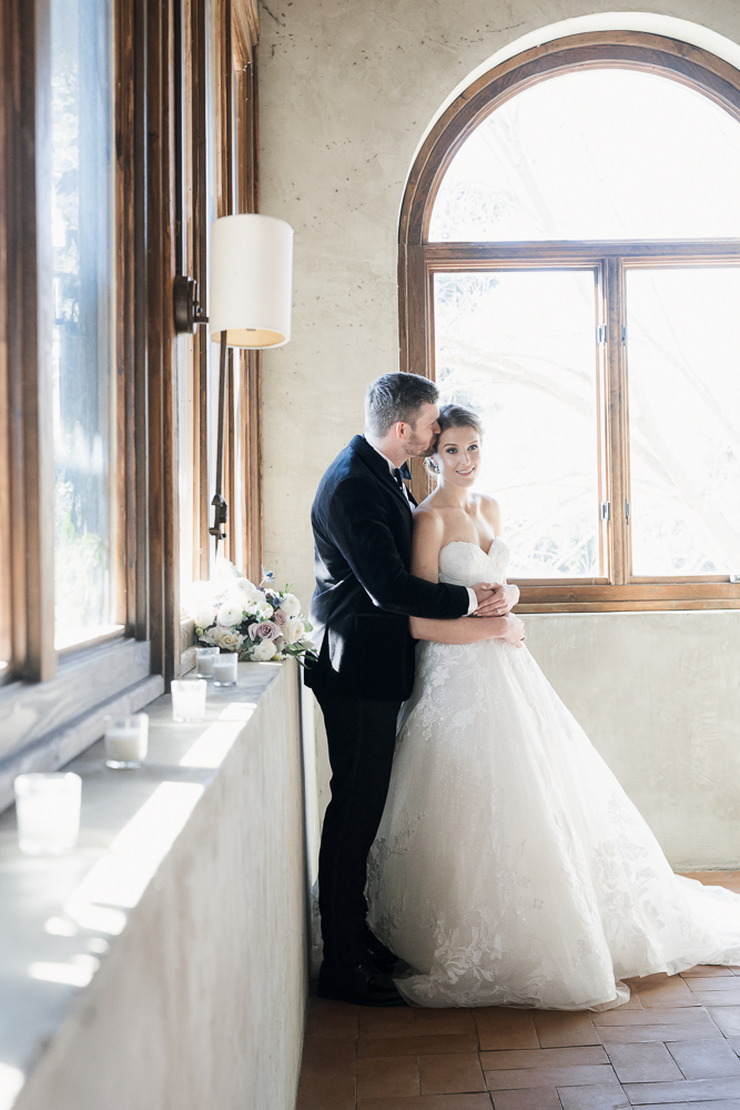 groom kissing the bride on the forehead