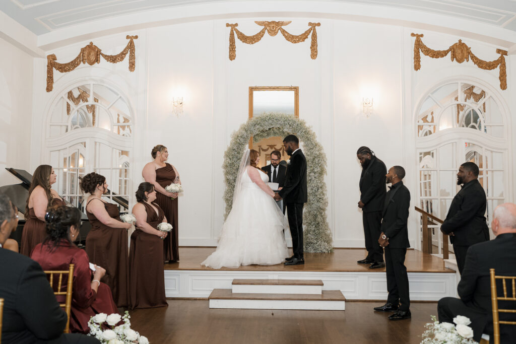 portrait of the bride and groom holding hands during their intimate wedding ceremony