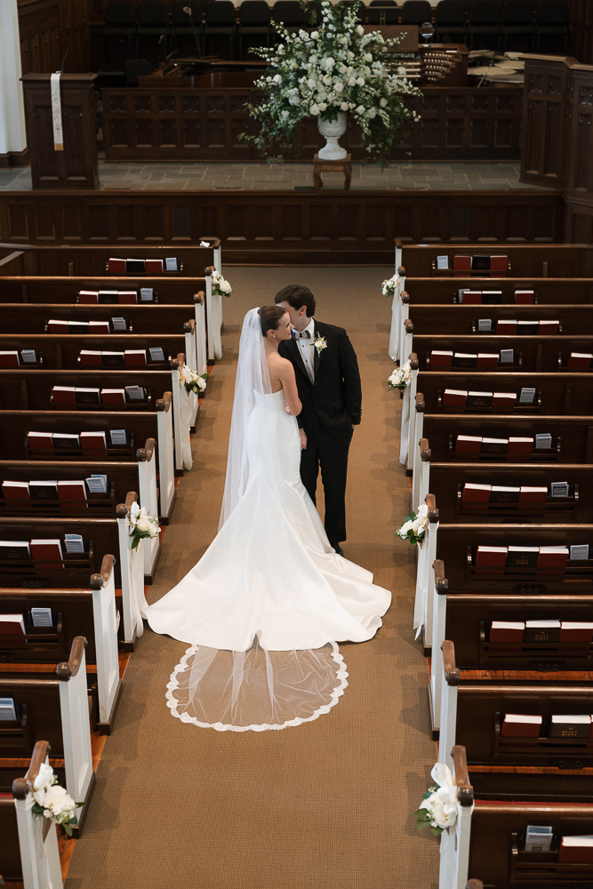 groom kissing the bride on the cheek