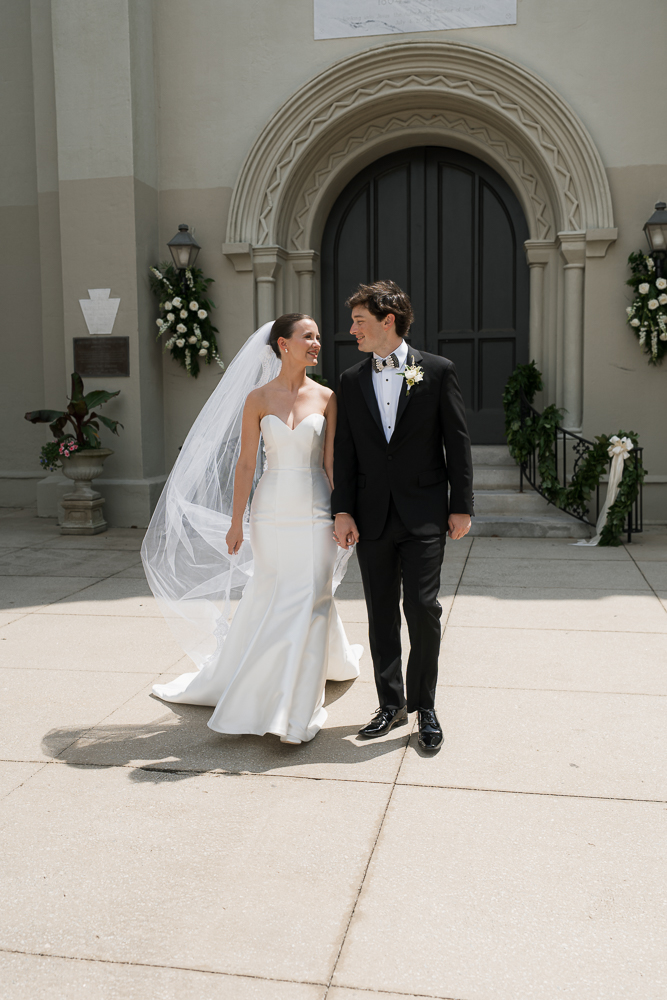 cute picture of the bride and groom holding hands
