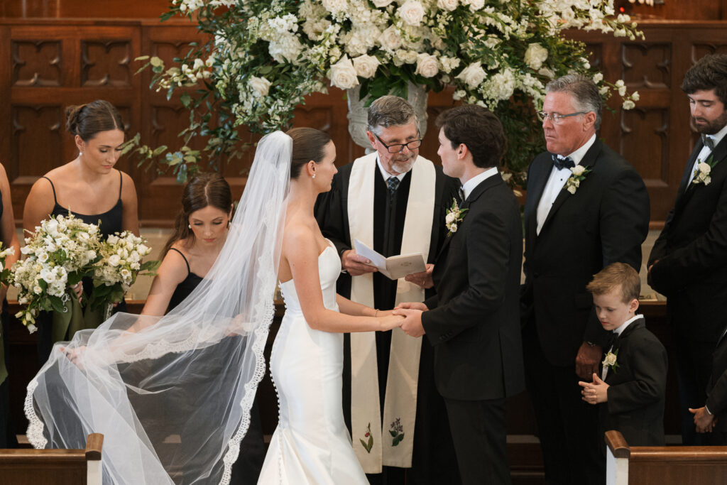 bride and groom holding hands during their ceremony