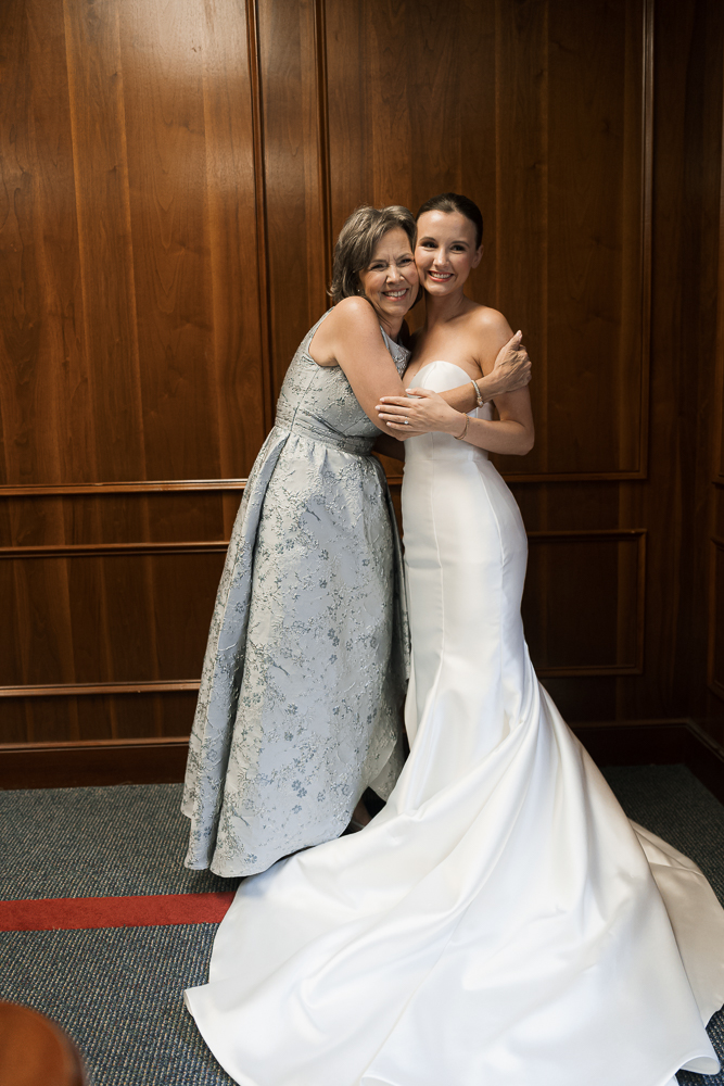 cute picture of the bride and her mom hugging