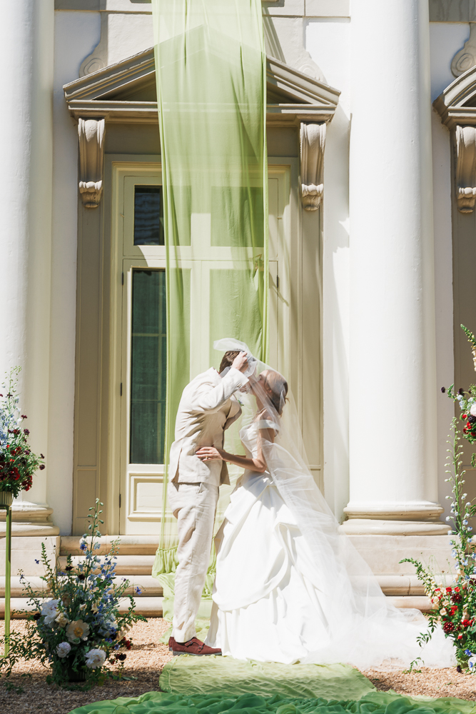 portrait of the newlyweds kissing