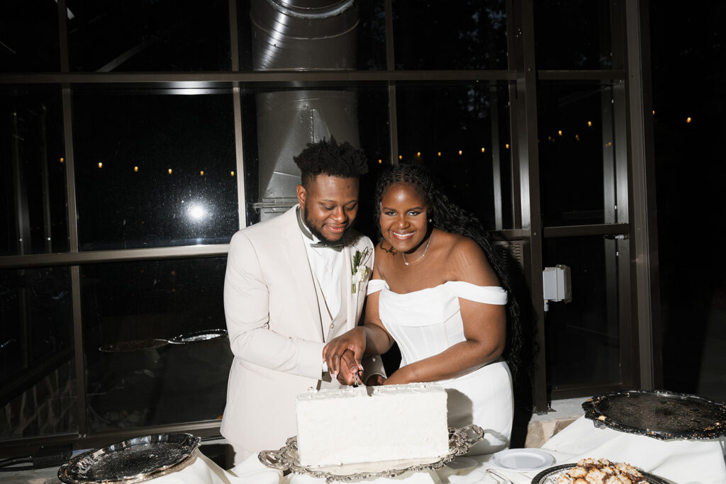 Portrait of the newly married couple cutting their wedding cake