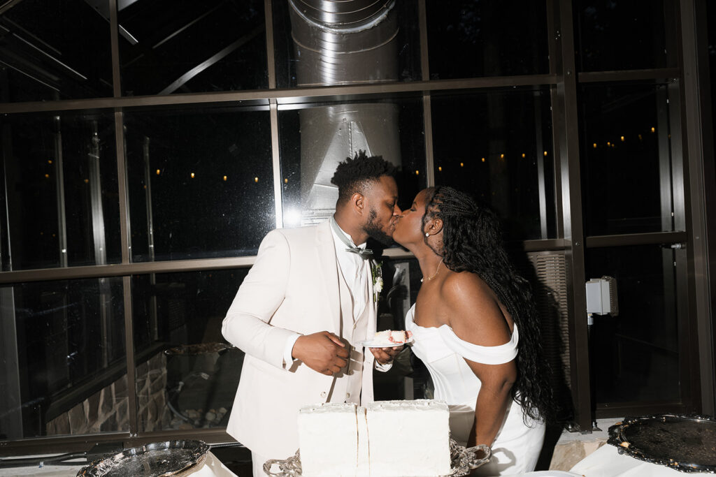 Cute picture of the newly married couple kissing at their wedding reception