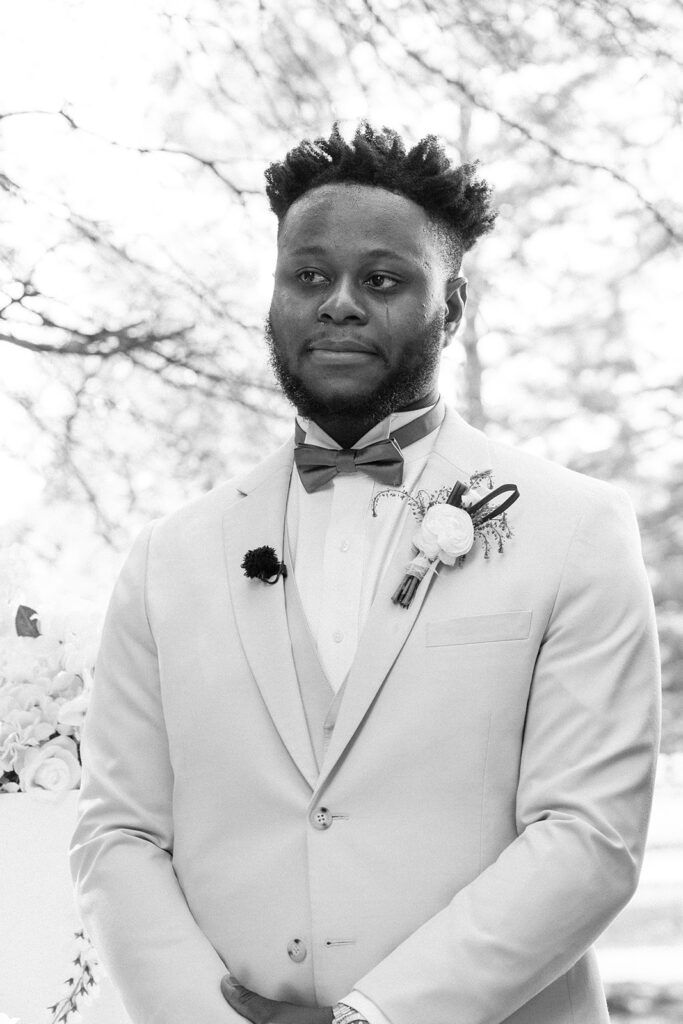 groom emotional watching the bride walk down the aisle