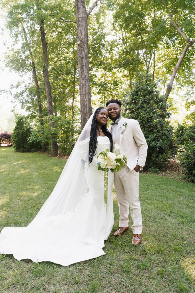 bride and groom smiling at the camera during their bridal portraits