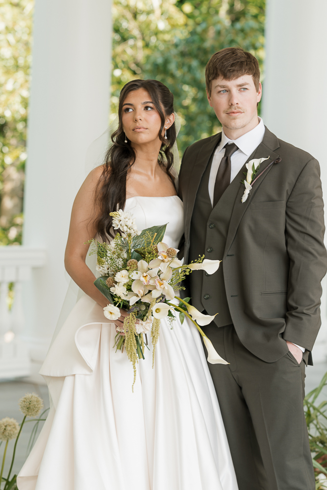 bride and groom smiling at the camera during their photoshoot