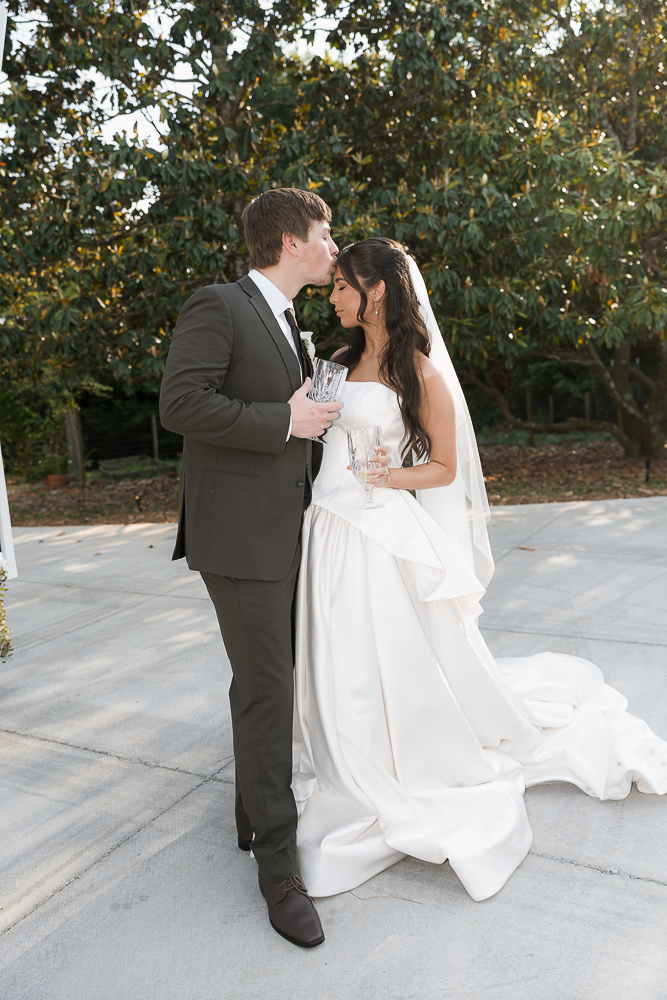 groom kissing the bride on the forehead