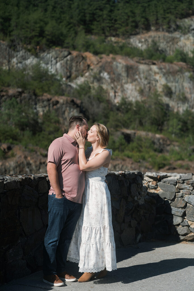 cute picture of the newly engaged couple kissing